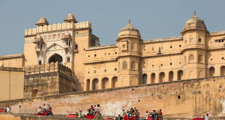 The Amber Fort with visitors riding elephants.