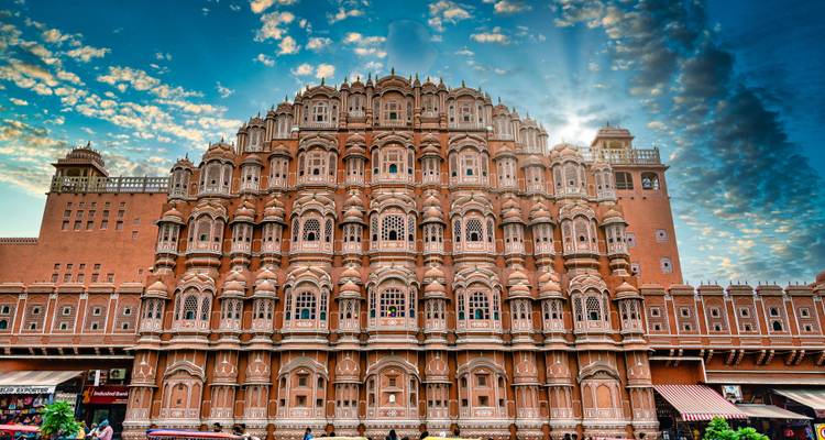 Intricate facade of the Hawa Mahal with a dramatic sky.