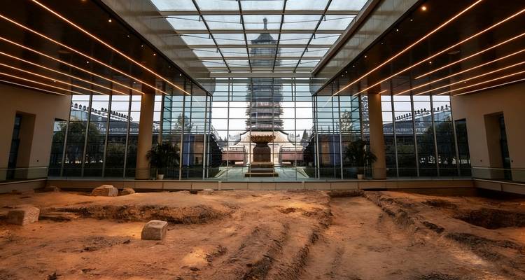 Indoor museum with archeological findings and view of a pagoda.