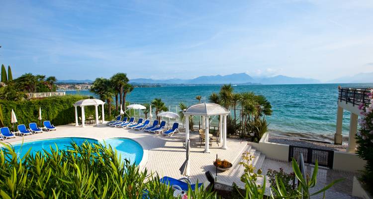 Poolside area with a view of the lake and mountains.