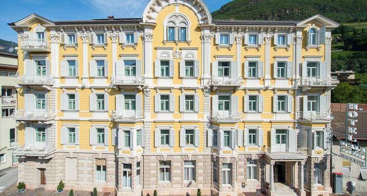 Yellow hotel building with decorative architecture.