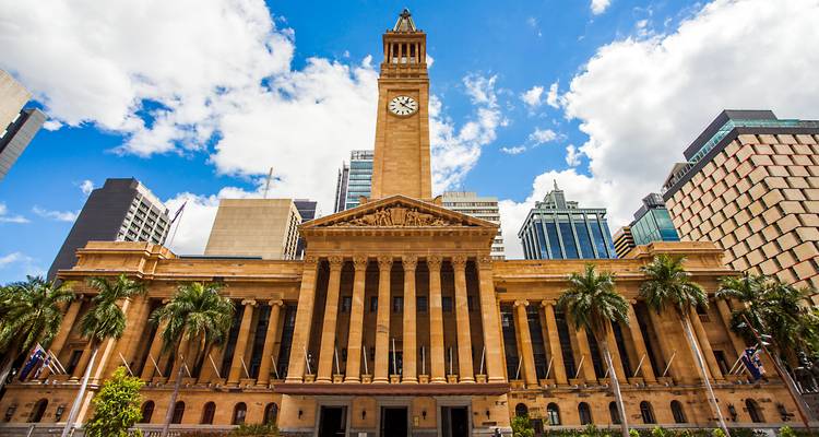 Historic building with a clock tower in a city.
