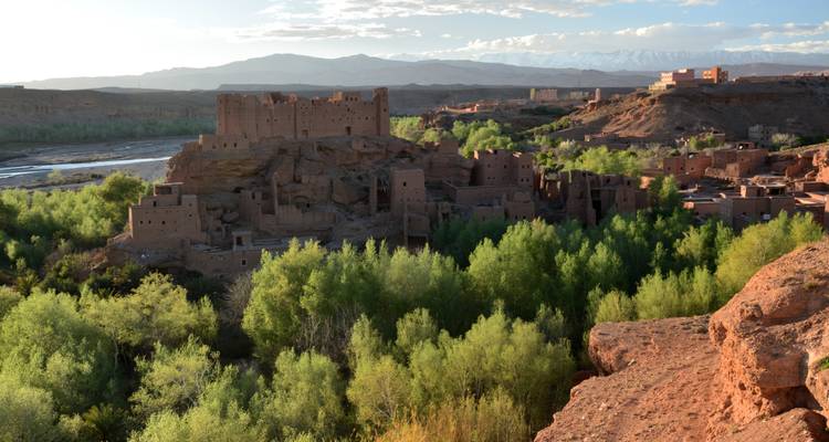 Vast Moroccan landscape with a historic village and lush greenery.