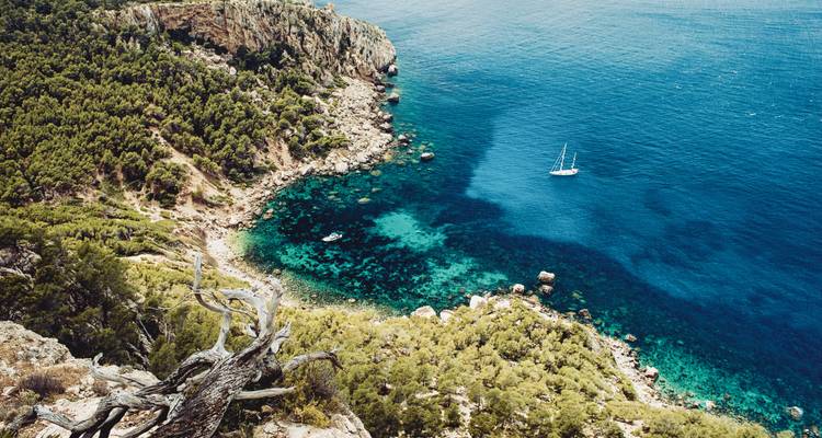 Aerial view of a rocky coastline with turquoise waters.