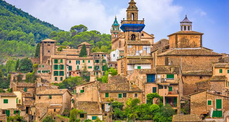 Picturesque village with historic stone buildings and a church.