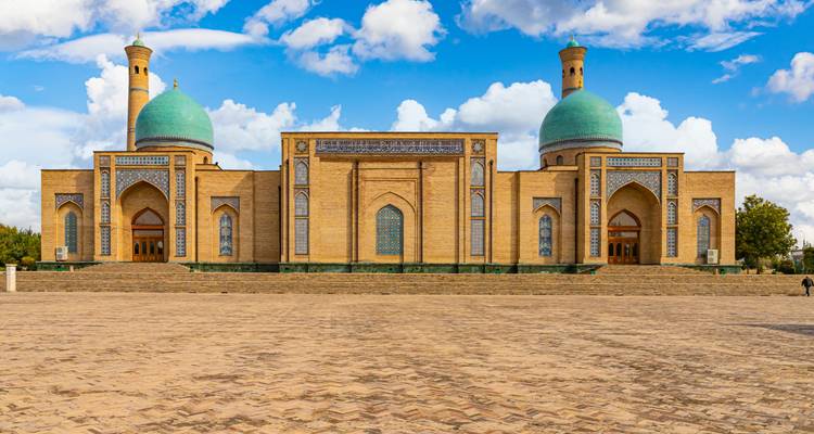 Historic mosque with large turquoise domes.