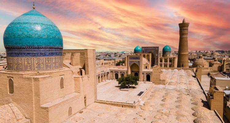 Dramatic sunset over historic city skyline.