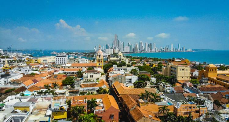 A panoramic cityscape combining modern skyscrapers with historic colonial buildings.