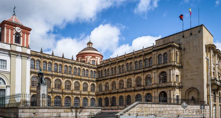A historic building with a grand facade under a bright blue sky.
