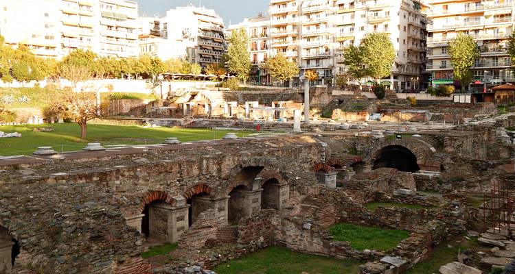 Ancient Roman archaeological site with modern apartment buildings.