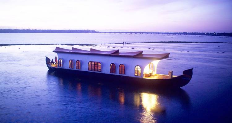 Houseboat on water during sunrise.