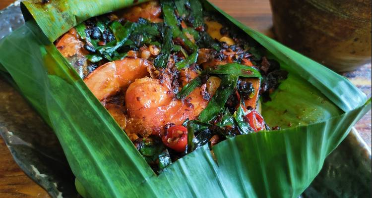 Spicy fish dish wrapped in a banana leaf.