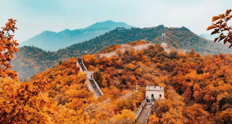 Autumn view of the Great Wall of China stretching through hills.