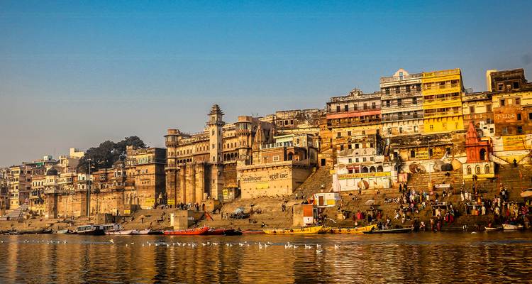 View of riverfront ghats and historic buildings.