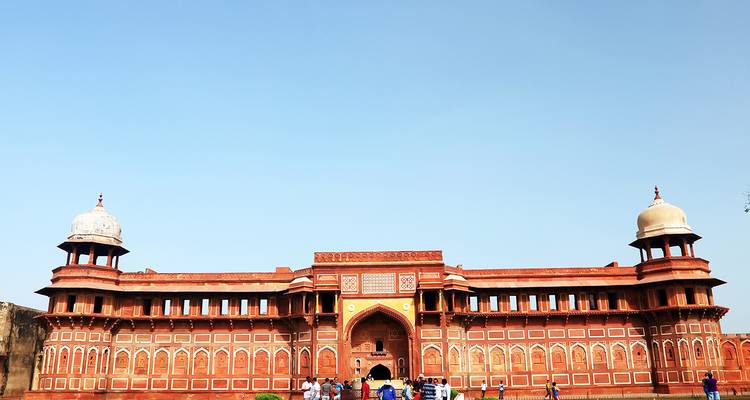 Historic fort complex with red sandstone archways and domes.