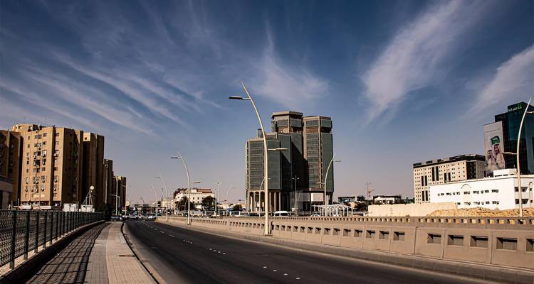 Modern street view with high rises under a clear sky.