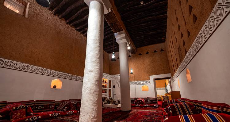 Traditional room interior with colorful rugs and decor.