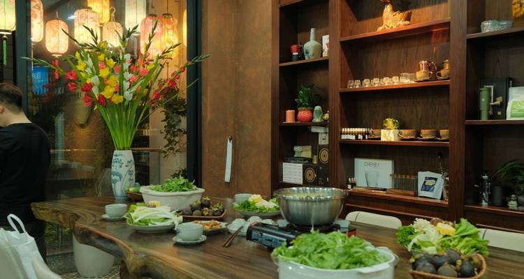 Indoor kitchen setup with fresh ingredients laid out on a rustic table.