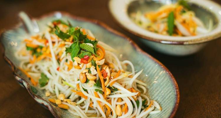 Close-up of a dish with fresh vegetables and herbs.