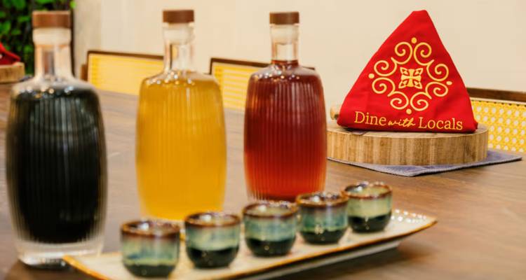 Close-up of colorful bottles and shot glasses arranged on a table.