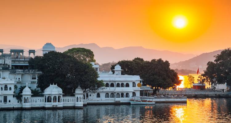 Sunset view over a lake with architectural buildings.