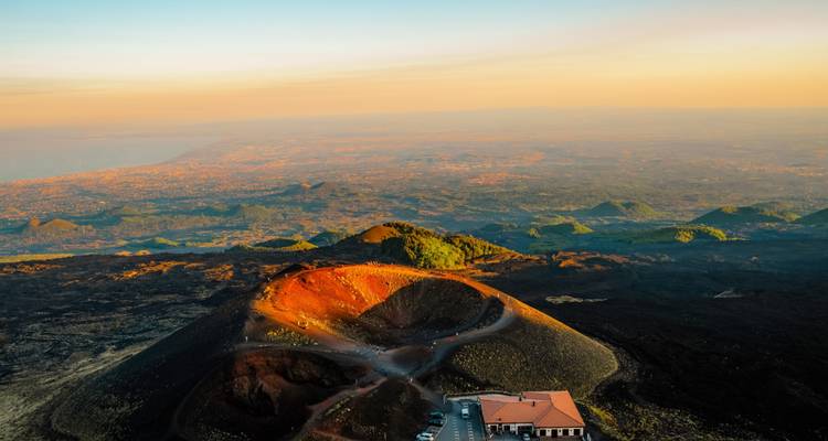 Aerial view of volcanic craters during sunset, overlooking the landscape.