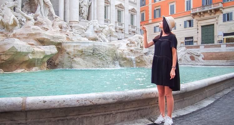 Woman posing at Trevi Fountain in Rome, Italy.