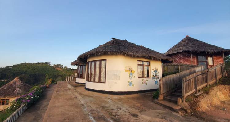 Traditionele hutten met rieten daken onder een heldere hemel.