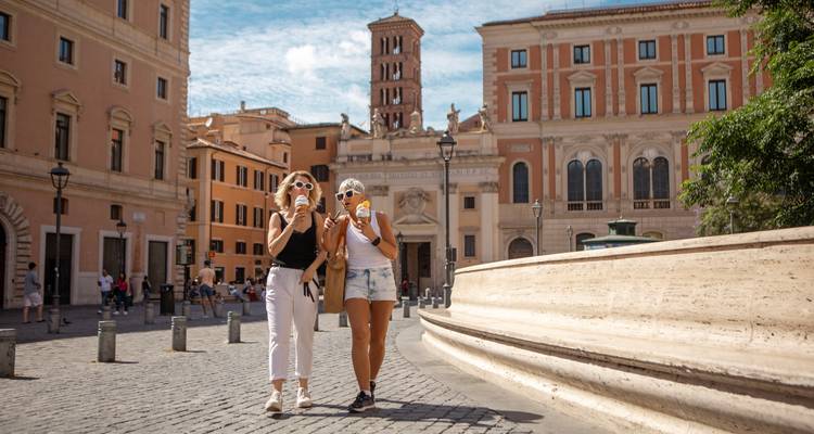 People enjoying gelato on a historic street.