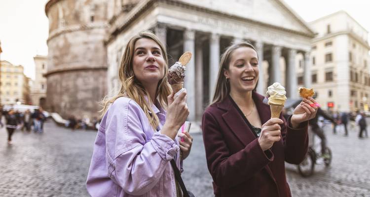 Two people eating ice cream in front of the Pantheon in Rome.