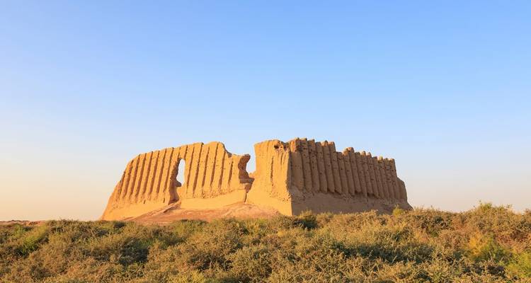 Ruins of an ancient fortress wall against a blue sky.