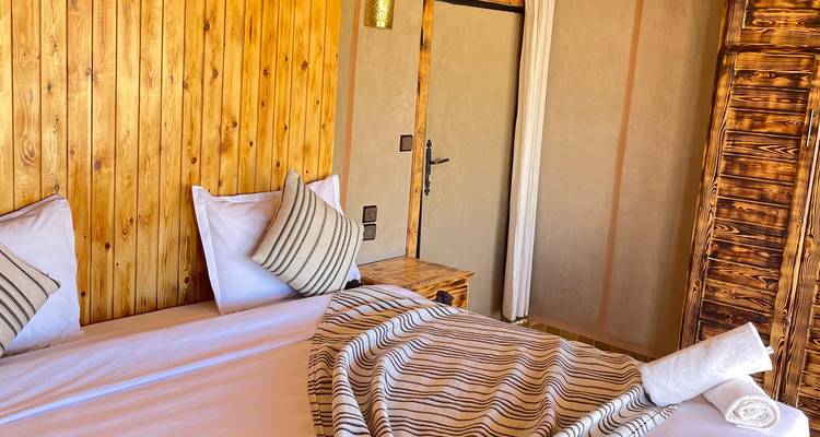 Simple desert camp interior with natural wood decor.