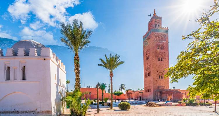 Majestic Koutoubia Mosque in Marrakesh with palm trees.