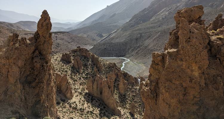 Rocky formations with a road winding through a desert landscape.