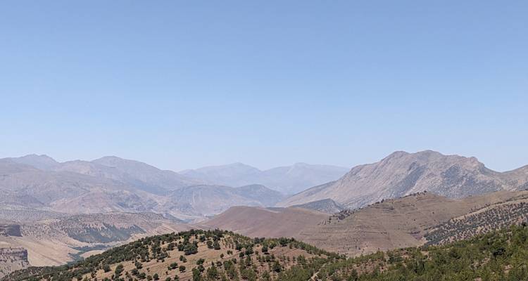 Hazy mountain view with blue skies.