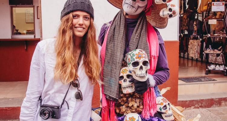 Person posing with a Dia de los Muertos-themed costume