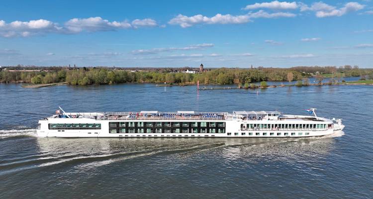 Cruise ship sailing on a river during the day.