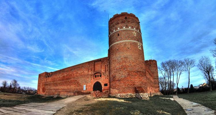 A red brick fortress under a blue sky.