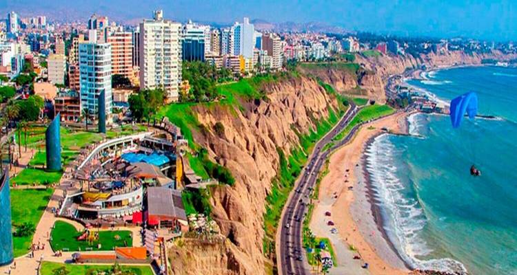 Aerial view of a coastal city with cliffs and beaches.