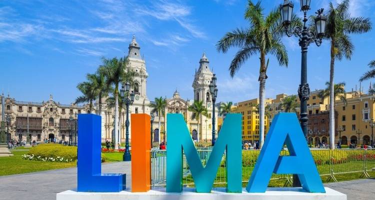 City square with historic cathedral and LIMA sign.