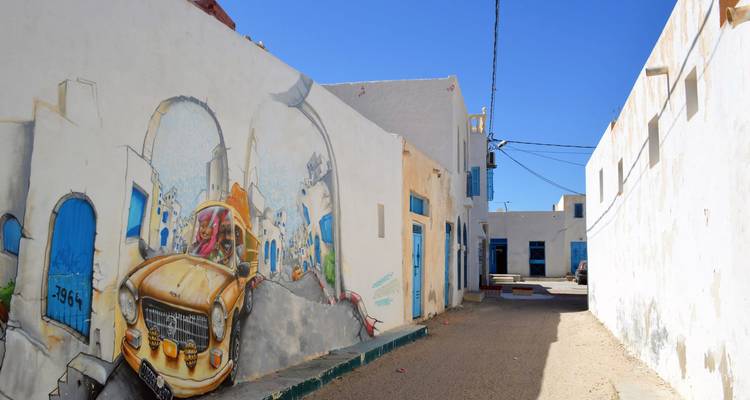 A street with a mural depicting a vintage car.
