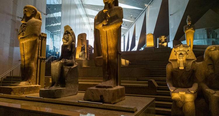 Ancient Egyptian statues displayed in a museum setting.
