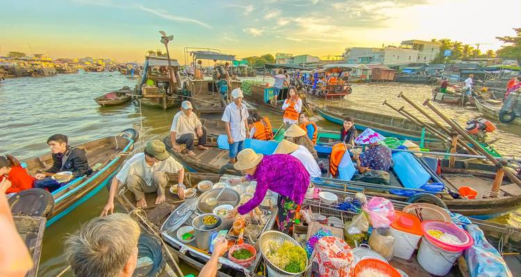 Scène animée de marché flottant avec divers bateaux et des gens qui échangent des marchandises.