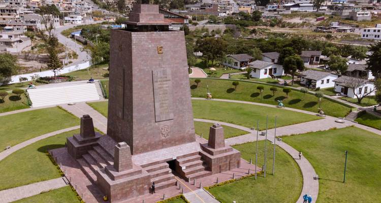 A monument surrounded by greenery in a city.
