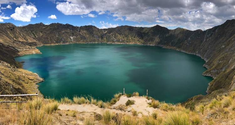 Quilotoa crater lake surrounded by mountains.