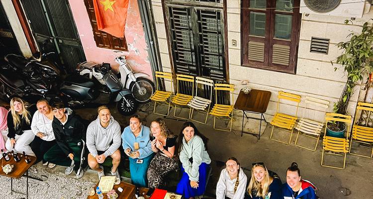 Large group enjoying a meal together at an outdoor cafe.