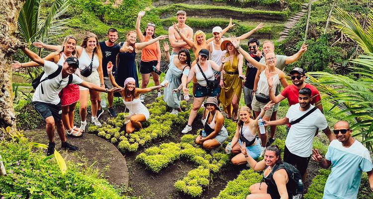 Large group of people smiling and posing in rice terraces.