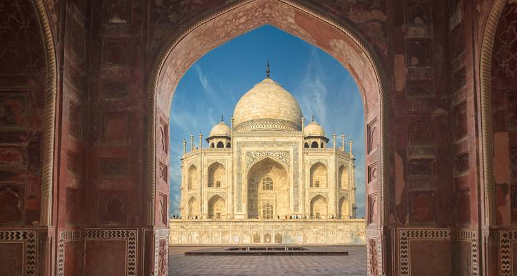 View of the Taj Mahal through an arched doorway.