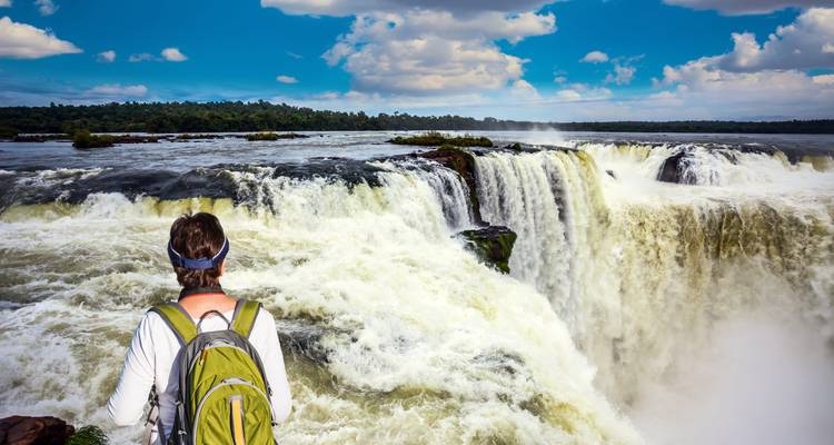 Person observing Iguazu Falls from a viewpoint.