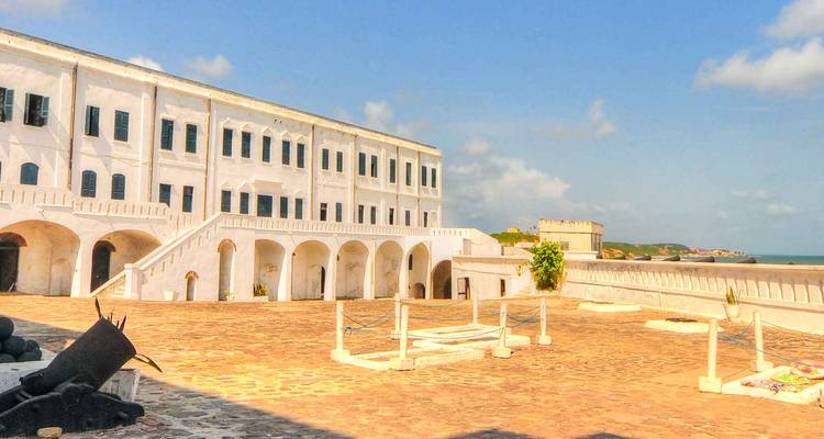 A historic white fort with a spacious courtyard under a clear sky.